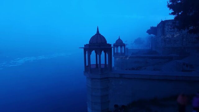 Scenic view of Brahmand Ghat on Yamuna river in Mathura, Uttar Pradesh during foggy morning. Historic riverside monument with peaceful spiritual atmosphere, showcasing Indian culture, heritage.