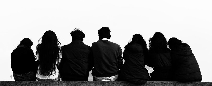 Young teenage indian students people guys girls sit on viewpoint watch blue sky  Group team of seven 7 happy people sits isolated on white heaven background. Travel vacations Back rear view