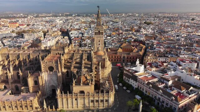Aerial view of the Seville Cathedral and Giralda tower at sunrise, panoramic shot of the historic city center in Seville, Spain. Historic cityscape of Seville