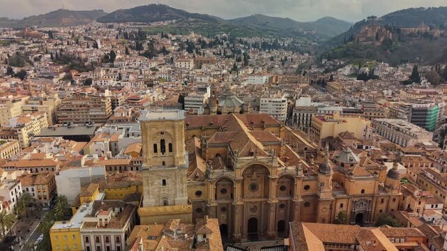 erial drone shot of Granada Cathedral and city rooftops, historic renaissance architecture in Andalusia Spain. Granada Cathedral during morning, Spain