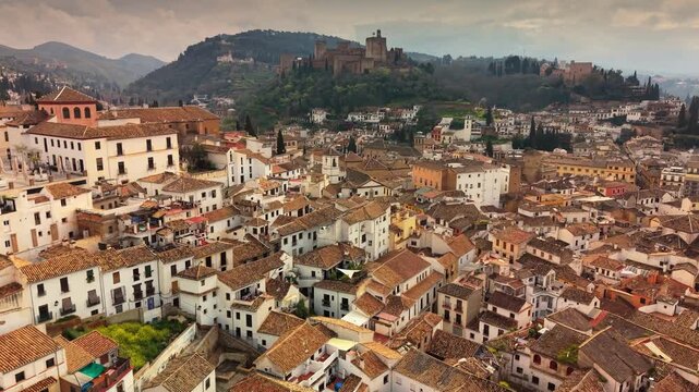 Aerial view of the historic Albaicin district in Granada, white houses and narrow streets with Alhambra in background. Old moorish quarter of Albaicin in Granda, Spain