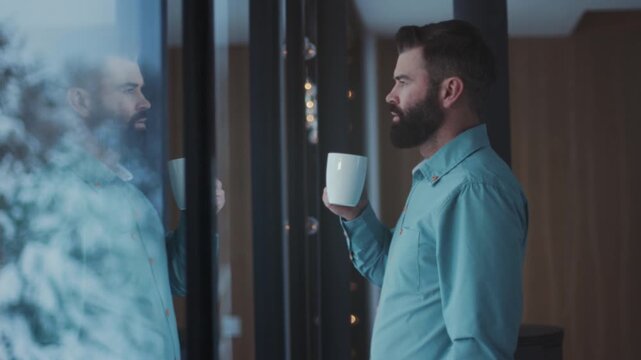 Gentle morning contemplation, Executive soaking in winter scenery reflected in coffeestained windowpane thoughtfully