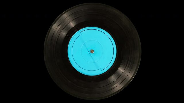 Old dirty black vinyl record with a blank blue label spins on turntable platter. Looped motion with transparent alpha channel and alpha matte