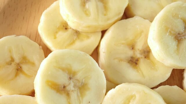 close-up captures the creamy allure of sliced bananas. Each uniform piece unveils a soft	