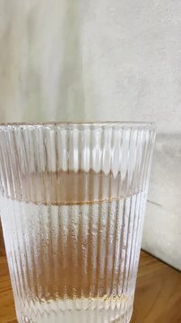 Half full glass of water with vertical camera motion. Ideal for lifestyle, hydration, and mindset concept visuals.