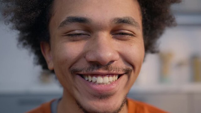 Happy African American man close up portrait smiling toothy looking at camera home guy healthy skin dental teeth white skincare laughing joyful ethnic male having fun enjoying smile expression inside