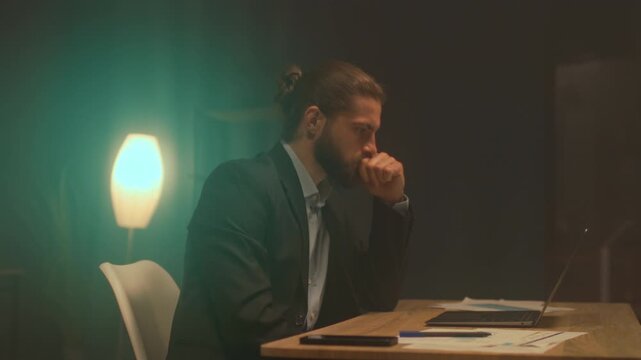Professional evaluates reports in calm office, Executive studies financial data during late evening work hours