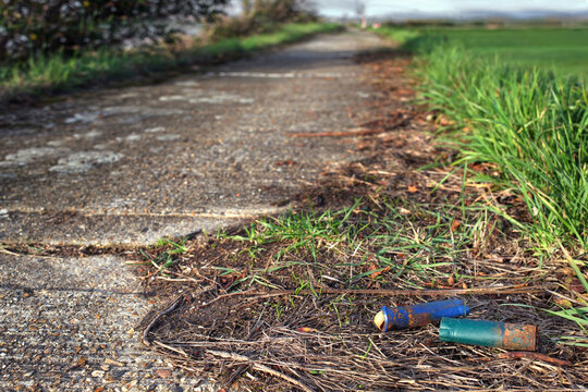Plastic Hunting Litter - Spent Shotgun Shells on a Coastal Sea Wall at Sunset, Human Impact on Marine Conservation Zones