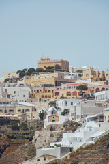 Naklejka premium Aerial view of Oia village in Santorini, Greece, with traditional white houses and the Venetian castle.