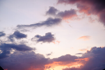 Scenic view of a mountain silhouette with dramatic clouds and colorful sunset sky. The peaceful natural landscape captures the beauty of evening light and the calmness of nature.