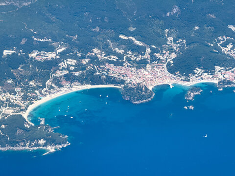 Parga town and Valtos Beach coastline on the Ionian Sea. Aerial view from plane window