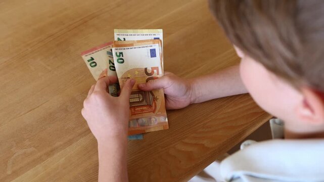 Close up hands holding euro banknotes, counting European cash money in natural light. Financial concept of income, savings, payment and budget management, economy and personal finance