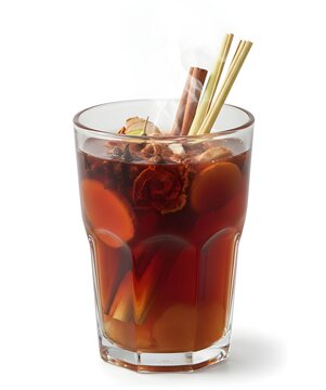 Traditional Indonesian wedang uwuh herbal drink with ginger, cinnamon, and lemongrass in a glass, isolated on white background with steam
