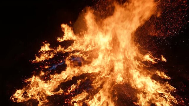 An abstract, close-up view of a towering bonfire with intense flames