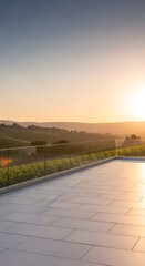 Fototapeta premium Sunset over vineyard terrace with glass railing overlooking rolling hills and golden sky a serene landscape view