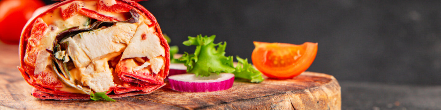 Shawarma wrap chicken and vegetables pink lavash doner kebab tasty snack fresh gourmet food background on the table rustic food top view copy space dark background marketing concept photo