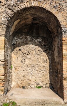 Ancient Roman arch niche wall in Pompeii ruins