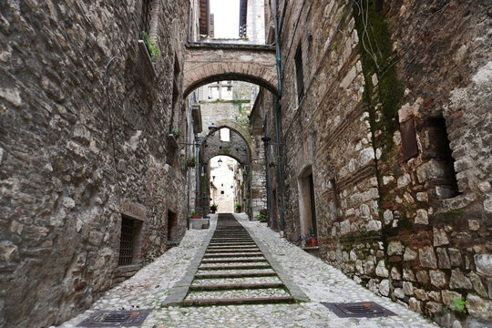 Picturesque alley with stairs in the medieval town of Narni. Umbria region, central Italy. Medieval city: a typical old street. Holidays in Italy. Ancient italian city rich in history. A cobblestone s