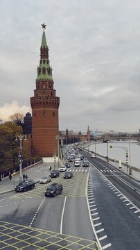 MOSCOW, RUSSIA - OCTOBER 2025: Traffic on the Kremlin Embankment with the Vodovzvodnaya Tower in the background.