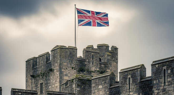 The union jack flag flying proudly atop the stone battlements of a historic castle in england