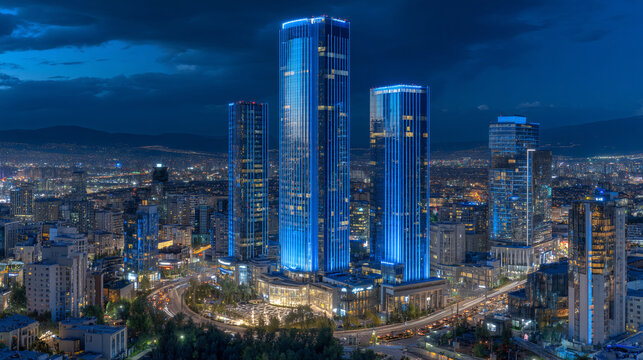 City skyscrapers illuminated at night boast architectural grandeur