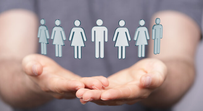 Concept of team and togetherness represented by hands holding illustrated people icons, symbolizing community and mutua