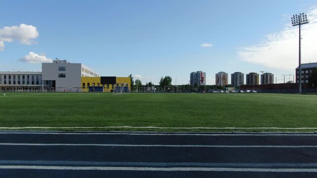 Low lateral drone flight over football field