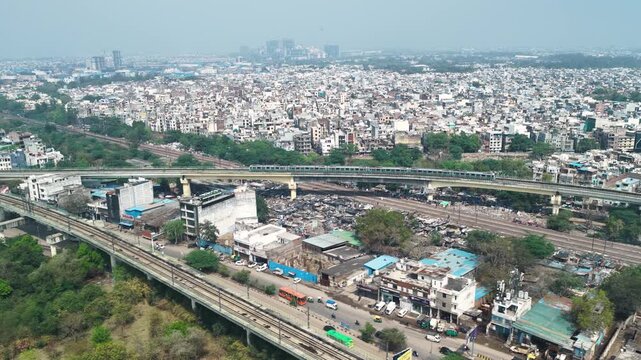 Aerial view of delhi metro passing through dense area in new delhi