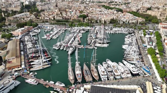 Detailed aerial view of Palma Cathedral and the fortified old town of Palma de Mallorca on Mallorca, Spain. The video highlights Gothic architecture, historic walls, waterfront promenade, and dense ur