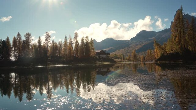 Scenic autumn landscape of Lago di Federa with Croda da Lago peak surrounded by larch forest in Dolomites, Italy