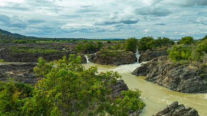 Khone Phapheng Waterfall, the largest waterfall on the Mekong River, features powerful multi-tiered cascades rushing over massive rock formations, creating one of the most dramatic natural © Narong Niemhom