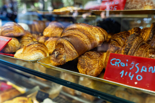 Freshly baked croissants in bakery display case