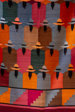 Colorful Woven Textile with Stylized Figures and Geometric Pattern