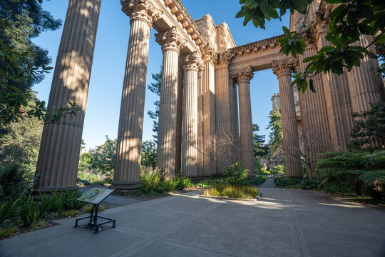 Sunlight filters through the towering Greco-Roman colonnades of the Palace of Fine Arts, creating a grand architectural corridor in the heart of San Francisco, California.