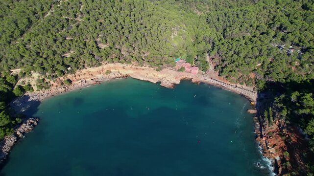 Aerial images of cala Saladeta, on the island of Ibiza during a sunny summer day, Balearic Islands, cala salada, 4k 30fps