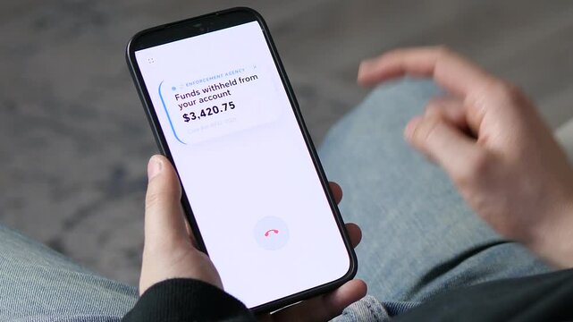 A person answers a fake call from an Enforcement Agency leading to a fraudulent bank notification of withheld funds. Concept of phone scams, identity theft, and digital financial crimes. Perfect for