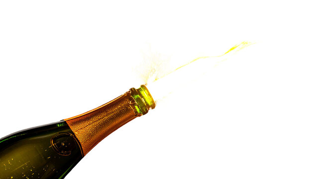 Close-up of a champagne bottle exploding with celebratory foam against a black background