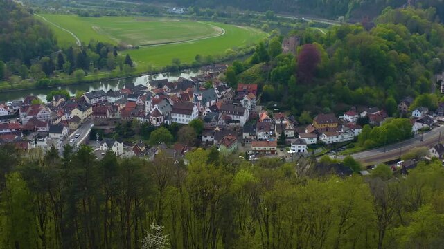 Aerial view of the city and castle Neckarsteinach in Germany beside the river neckar. On a sunny spring day