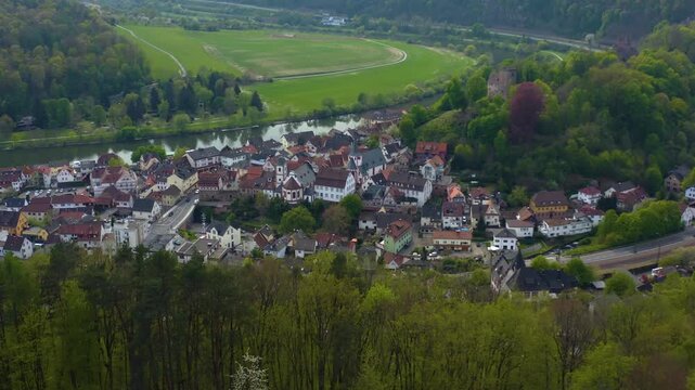 Aerial view of the city and castle Neckarsteinach in Germany beside the river neckar. On a sunny spring day