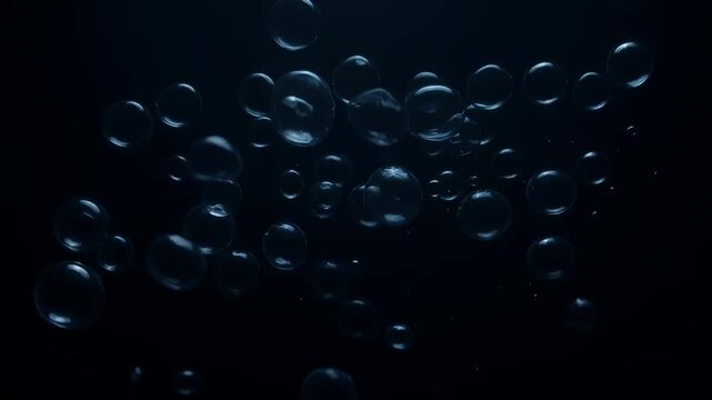 Cinematic air bubbles rising in dark water, underwater oxygen bubbles floating against black background, deep sea aquatic texture