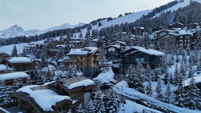Aerial view of Courchevel ski resort by winter, drone shot on a snowcapped  chalets and hotels, French alps, France 