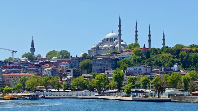 Suleymaniye Mosque in Istanbul, Turkey, dominates the skyline with its grand Ottoman architecture. The mosque features multiple cascading domes and slender minarets. It is set atop a hill