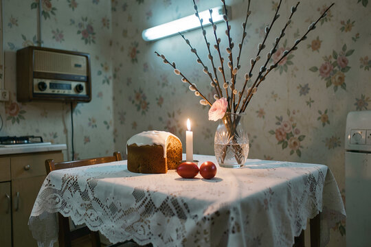 Traditional kitchen table with bread, candle, and flowers in vase
