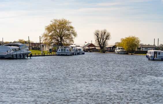 View down the River Thurne, Norfolk Broads. Captured from the river bank in the village of Potter Heigham