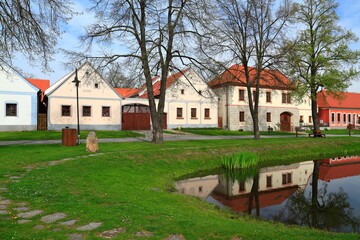 Fototapeta premium Historic Holasovice Village street with beautifully preserved South Bohemian Folk Baroque farmhouses