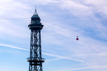 Cable car tower with gondola against blue sky © FotoV
