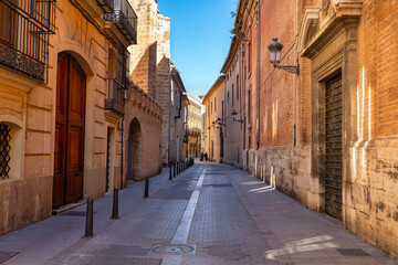 Naklejka premium Narrow picturesque streets with old stone buildings in the centre of Valencia, Spain.