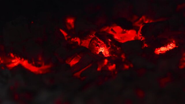 Fiery Sparks Glow. Intense Red Embers Emit Warm Glow While Shifting In Dusky Smoke Filled Surroundings. Media