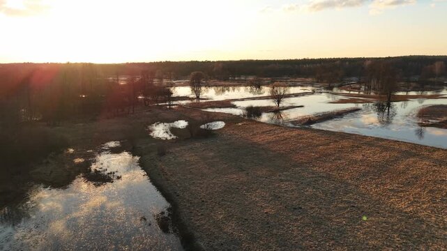 Golden Hour Forward Rise Over Sunset‑Lit Floodplain