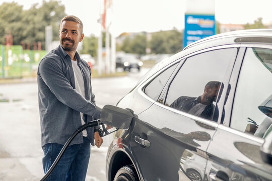 Man filling up car with fuel at gas station